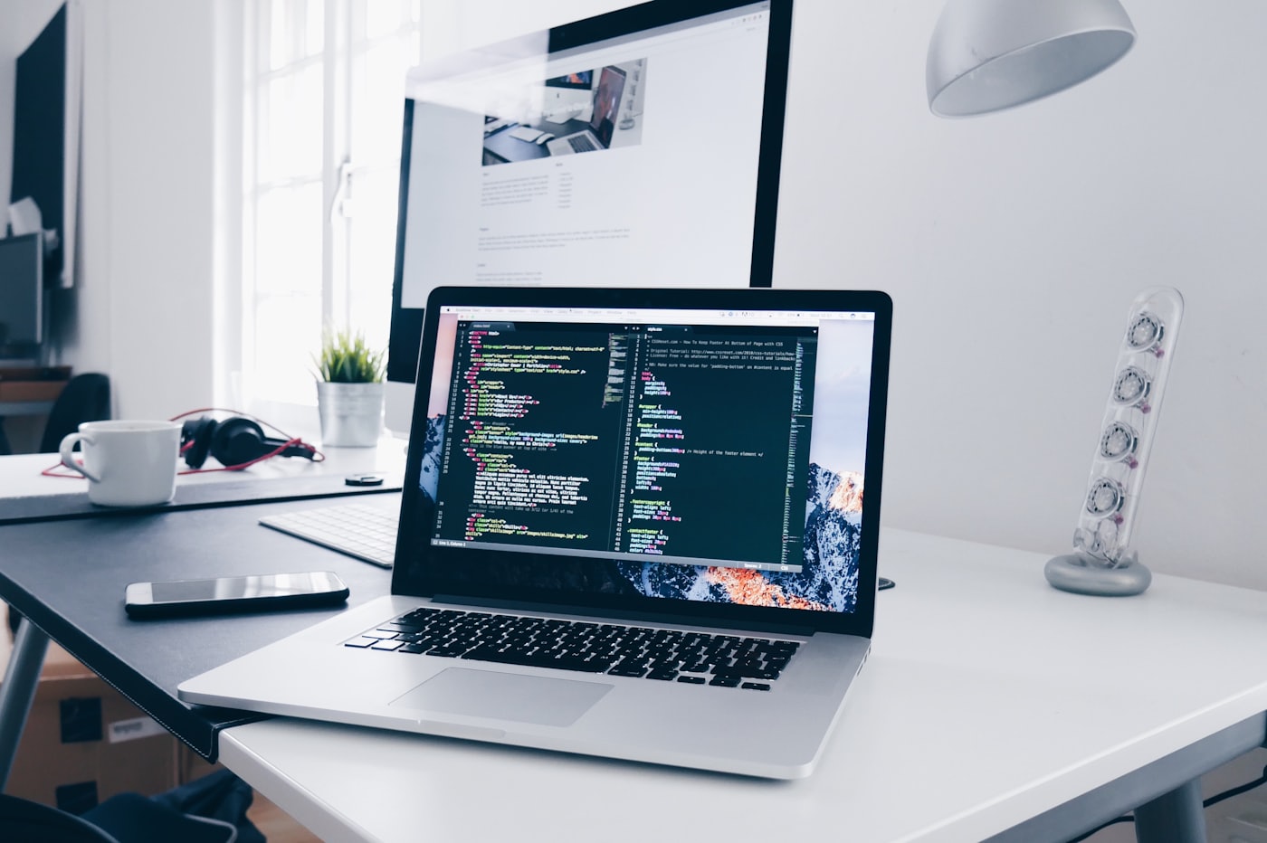 Engineer typing code in a dark editor while building a production website